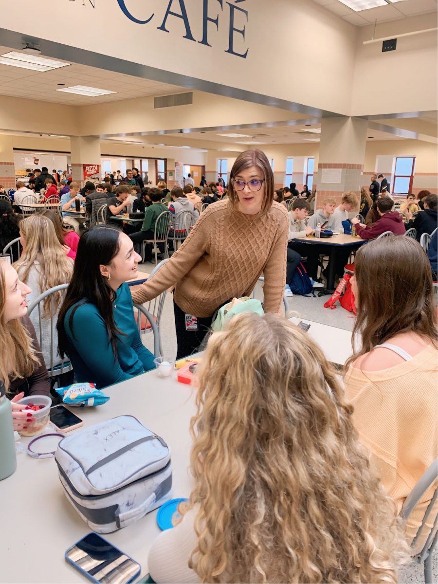 Mrs. Secor converses with some students during D Lunch