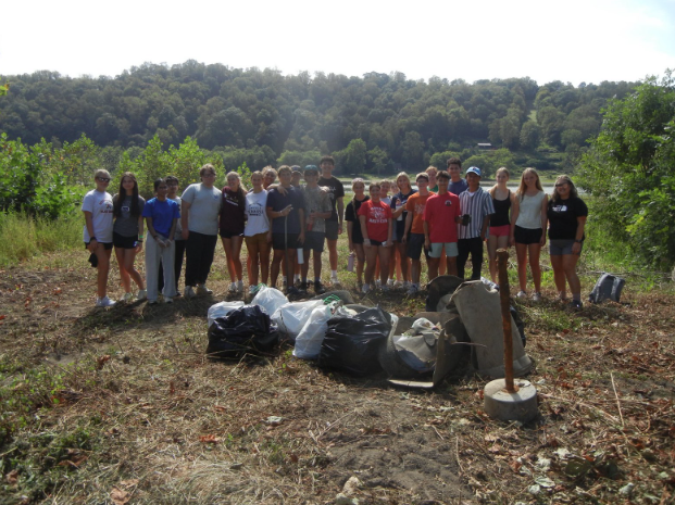 Students posing with the litter they helped clean up.